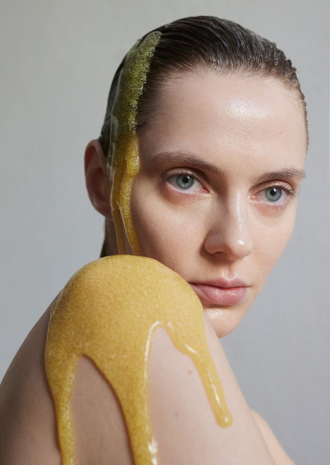 Beauty image of a woman with dripping body scrub running down her shoulder.