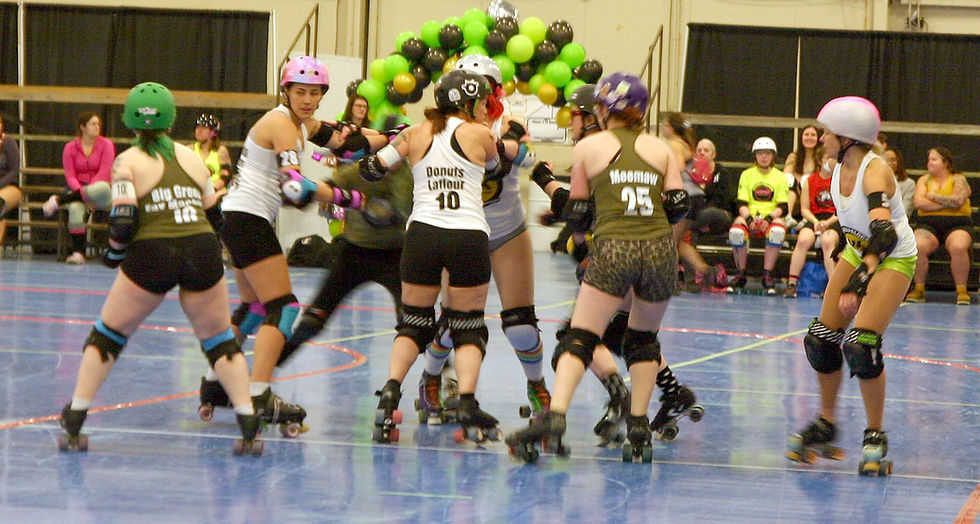 Players jostle for position during the Green vs. White matchup at Scrimmapalooza, hosted March 28 by Norfolk County Roller Derby.