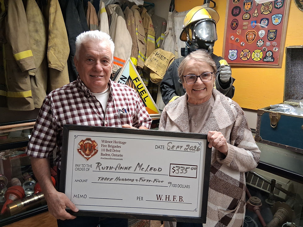 Wilmot Heritage Fire Brigades president Peter Gingerich presents Baden resident Ruth-Anne McLeod with a cheque for $350, her winnings from the September monthly 50/50 draw supporting the preservation of historic fire trucks and firefighting equipment. Contributed photo
