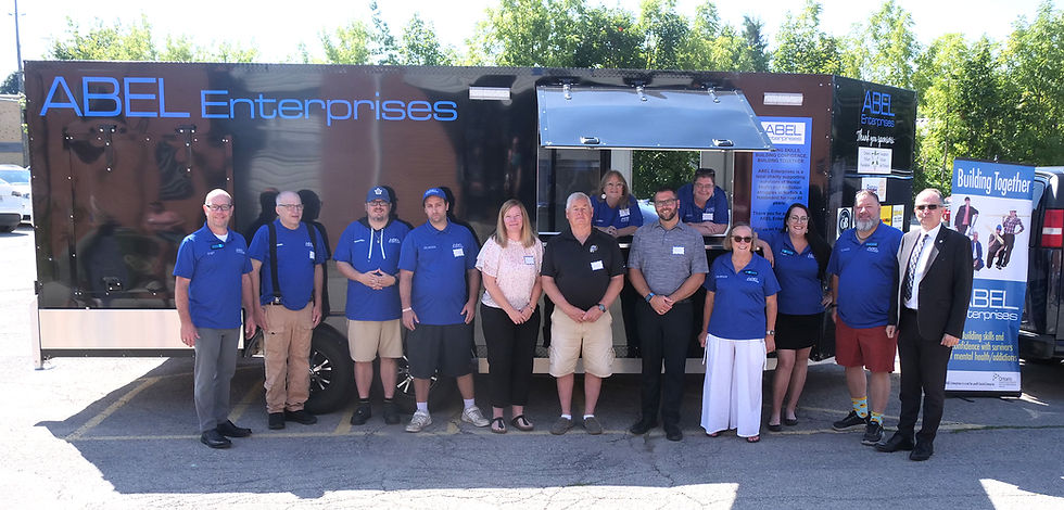 ABEL Enterprises’ fundraising committee and visiting dignitaries stand next to ABEL’s new trailer, purchased using grant funds from the Ontario Trillium Foundation.