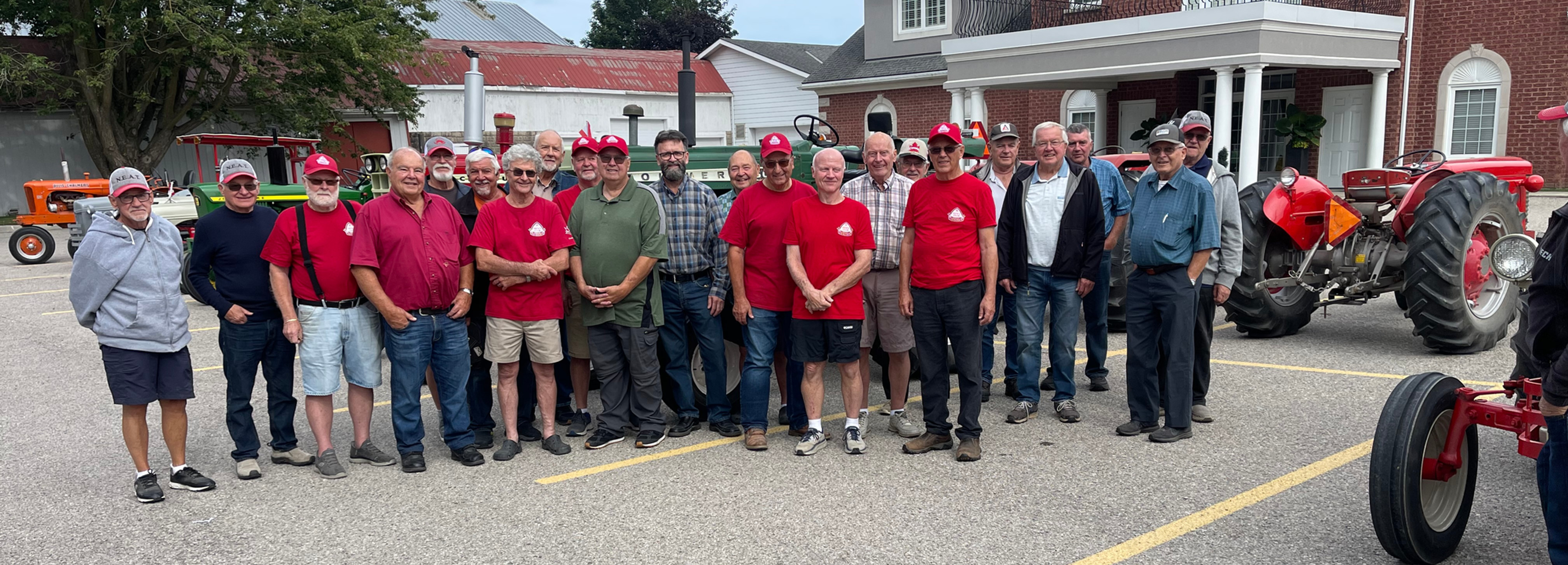 Tavistock Men’s Club members, wearing red shirts, gather with members of the North Easthope Antique Tractor Club following last week’s fundraising breakfast. Dozens of antique tractors brought by NEAT members are parked in the background across from the Men’s Club Hall on Woodstock Street North in Tavistock. Gary West photo