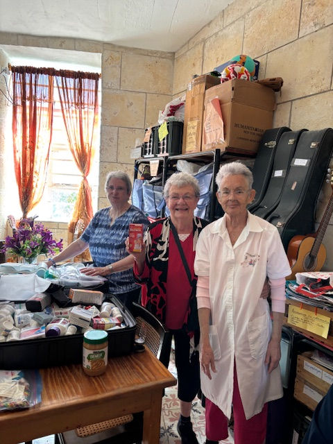 From left, Canadian Women’s Missionary Society president Cathy Reid and Jean Aitcheson open a suitcase of donated medications alongside a Cuban church volunteer and retired pediatrician.