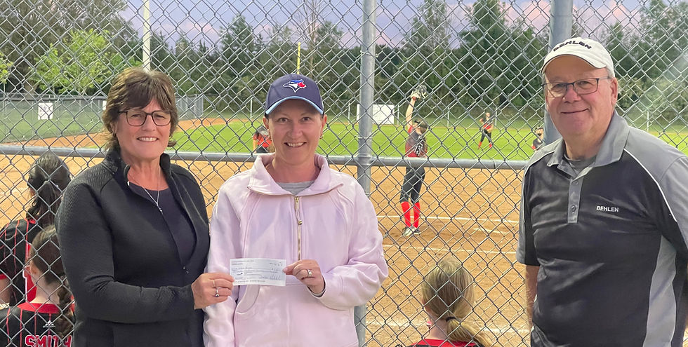 Shakespeare Field Day chair Deb Bell, left, presents a cheque for $2,365 to 50/50 draw winner Lindsay Weicker during a presentation at the Shakespeare ballpark on Monday evening. Joining them is Shakespeare Community Athletic Association president Paul Bender. In the background is Weicker's daughter, Leah, a member of the U15 Shakespeare Falcons, who helped sell tickets for the fundraiser. The Falcons went on to win their game by a wide margin. Gary West photo
