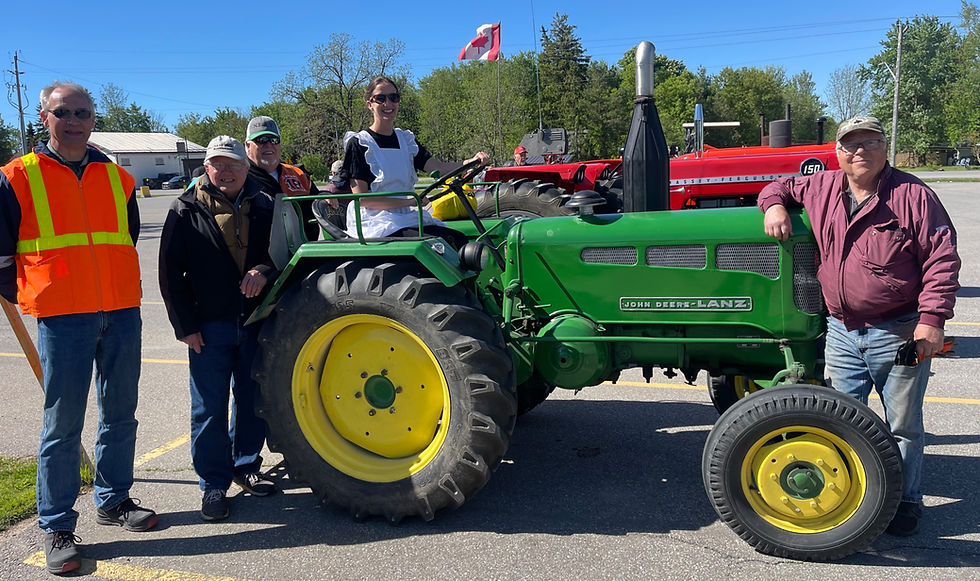 Anna Mae's owner Amanda Herrfort takes a seat on Ron Neeb's 1959 John Deere-Lanz tractor during the North Easthope Antique Tractor Club's breakfast gathering in Millbank. Joining her are, from left, Harold Bruulsema, John Schyff, Joe Detzler and Ron Neeb. Neeb said relatively few John Deere-Lanz tractors were produced. Originally built in Germany by Lanz, the company was later acquired by John Deere. The tractor produces 28 horsepower from a single-cylinder engine. Gary West photo