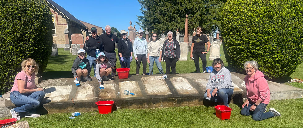 Volunteers from Trinity Lutheran Church in Sebastopol gather around the cemetery's memorial cairn during a cleanup and restoration day. Front row, from left, are Joan Ferguson, Chloe Hazeleger, Tessa Hazeleger, Linda Weitzel and Evelyn Coulthard. Back row, from left, are Paul Epp, Richard Wilker, Janet Heinbuch, Tricia Hendry, Annabelle Hendry, Kathy Wilker and Angie Moore. Gary West photo