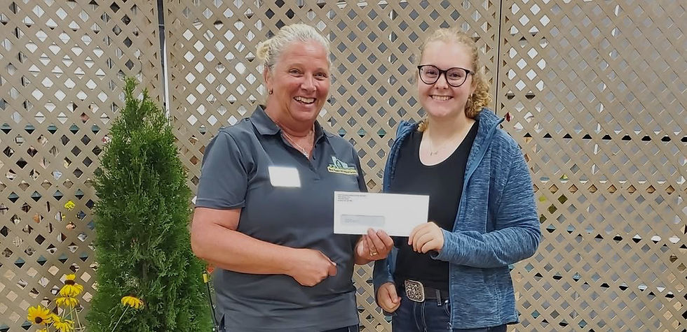 Renate McGillivray, president of the West Niagara Agricultural Society, presents the Tricia Vaughan Memorial Scholarship to Emily McGee, who is attending Guelph University this fall. ~ Ann Marie Chechalk photo