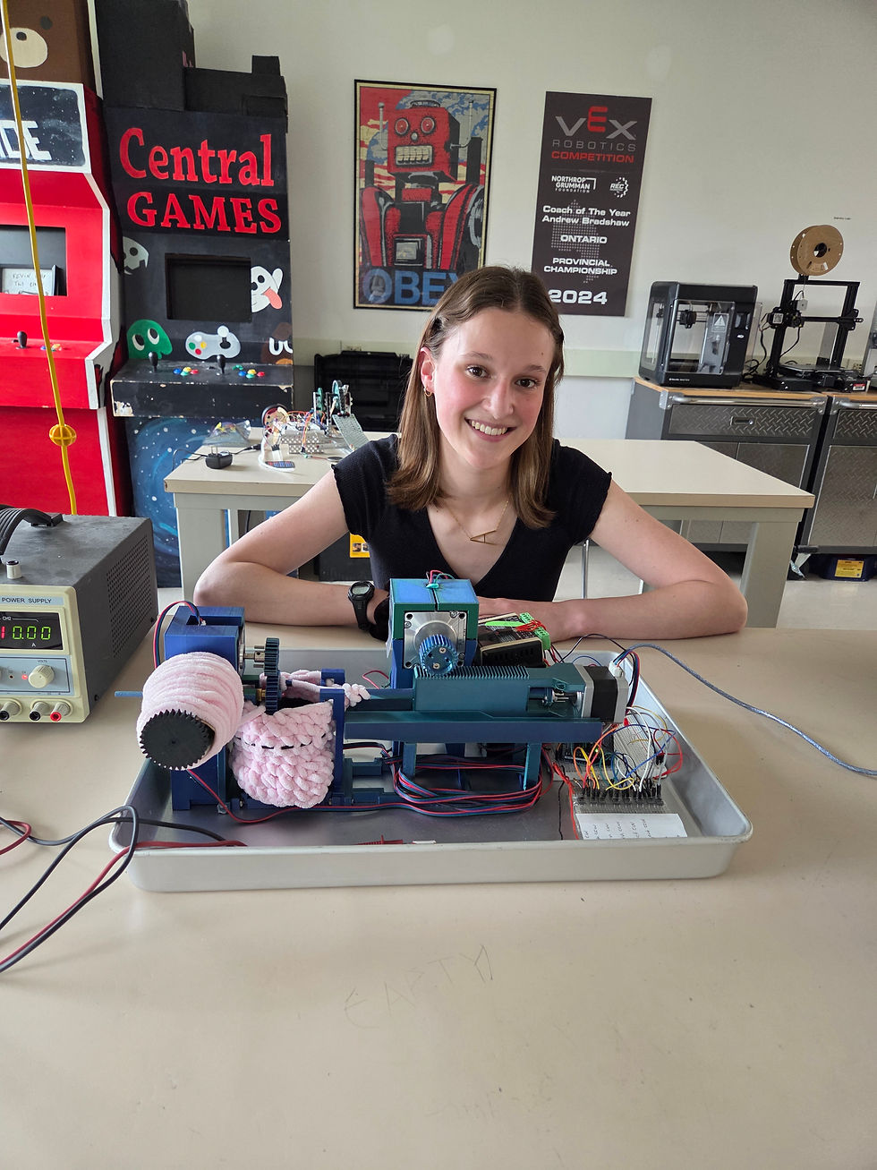Avery Durand, an SDSS Grade 12 student, poses with her robot built to crochet as part of her creative engineering project. Durand is going on to study engineering at McMaster University in the fall.