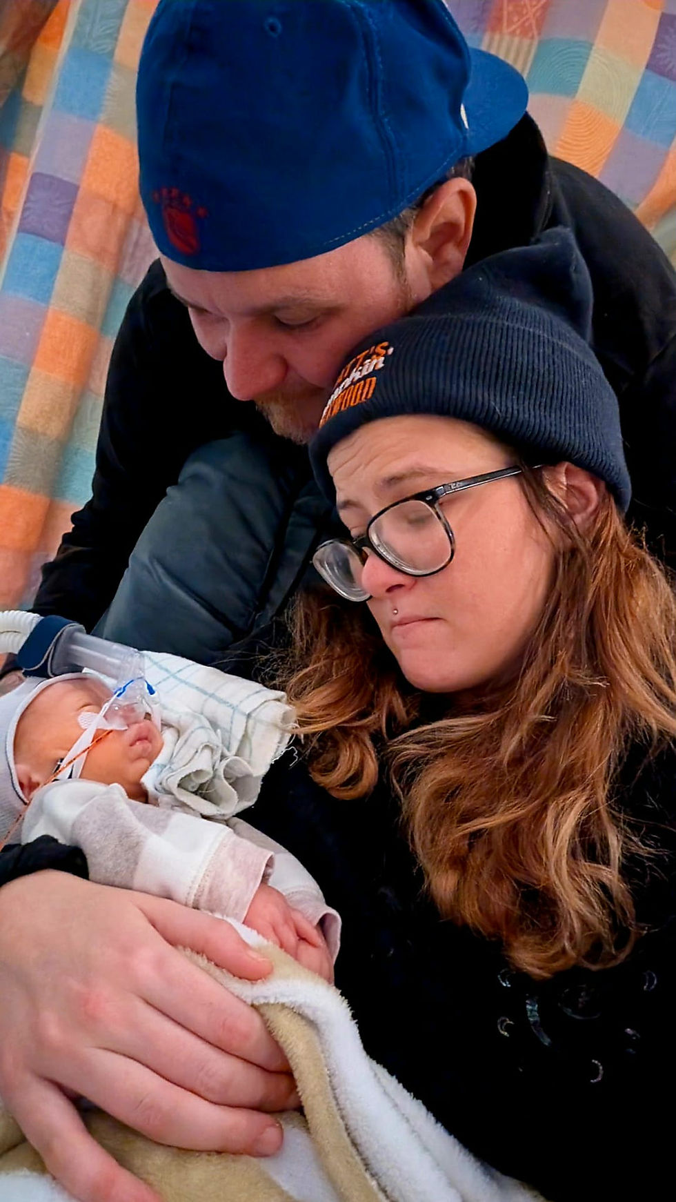 Chris Campbell and Emily Montgomery snuggle baby August.