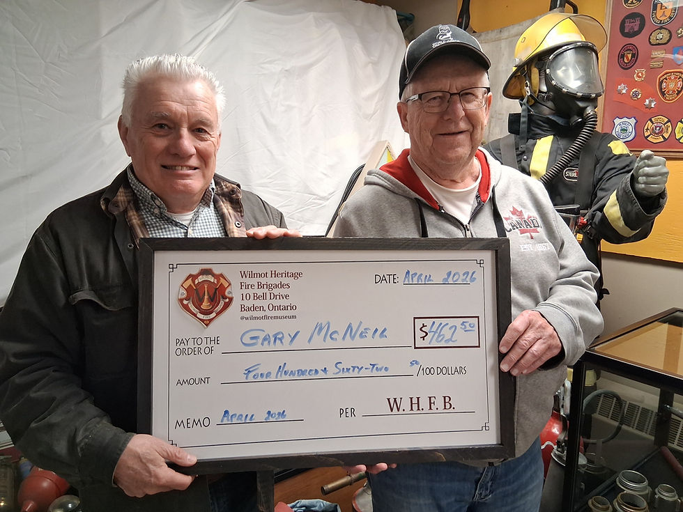 Wilmot Heritage Antique Fire Brigades president Peter Gingerich congratulates New Hamburg resident Gary McNeil after he won $462.50 in the brigade’s monthly 50/50 draw. McNeil says he always makes sure to purchase a ticket in support of the local organization. Contributed photo