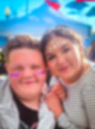 Two guests smiling together with colorful face sparkle