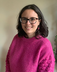 headshot of Bente Sterrett wearing a pink sweater, and smiling at the camera