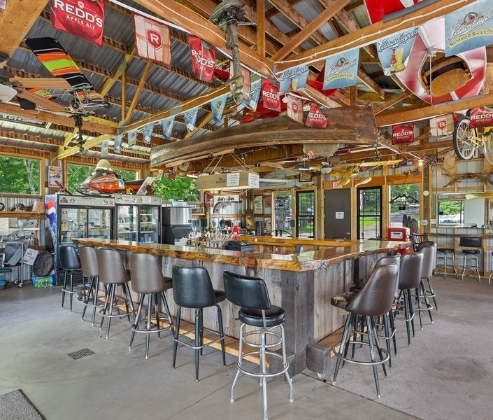 Interior of The Shed Bar with rustic wooden counter and stools