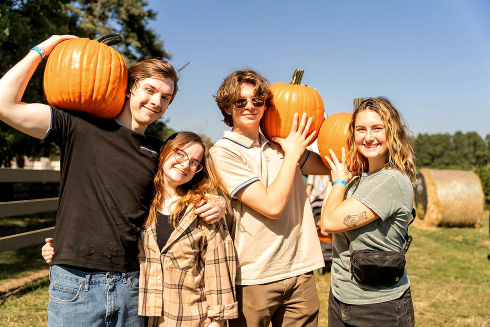 family holding pumpkins