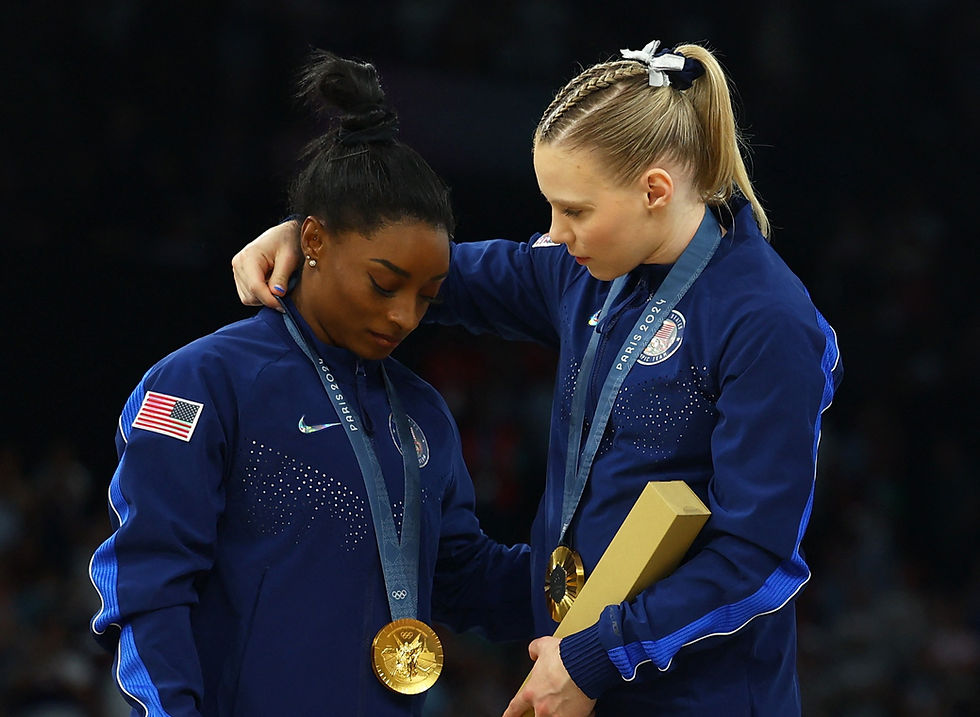 Paris 2024 Olympics - Artistic Gymnastics - Women's Team Victory Ceremony - Bercy Arena, Paris, France - July 30, 2024. Gold medallist's Simone Biles of United States and Jade Carey of United States celebrate with their medals on the podium. /Hannah Mckay/File Photo