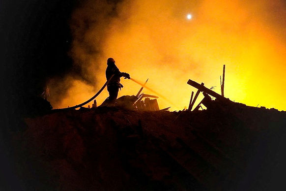 A firefighter extinguishes a fire in the aftermath of an attack, amid Russia's attack on Ukraine, given as Starokostiantyniv, Khmelnytskyi Region, Ukraine, in this handout photo released on August 6, 2023, courtesy of the Khmelnytskyi region administration/Handout via REUTERS/File Photo