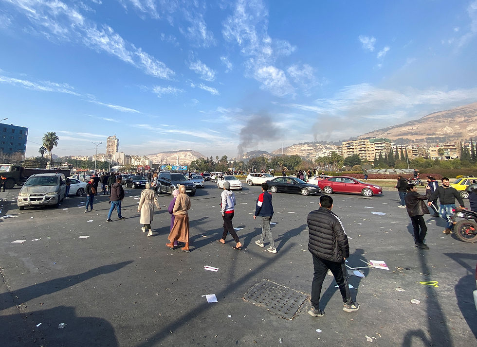 Smoke rises as people gather in Damascus, after Syrian rebels said on Sunday that they have ended Bashar al-Assad's 24-year authoritarian rule, in their first announcement on state television following a lightning offensive that took the world by surprise, Syria December 8, 2024. /Firas Makdesi