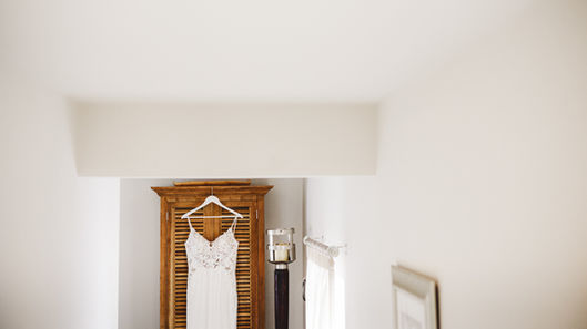 Wedding dress hanging in a wooden cabinet; a special moment. Craig Hickey Photo