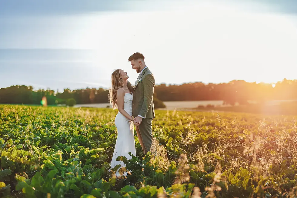 leicester wedding photographer in a field with a bride and groom at sunset