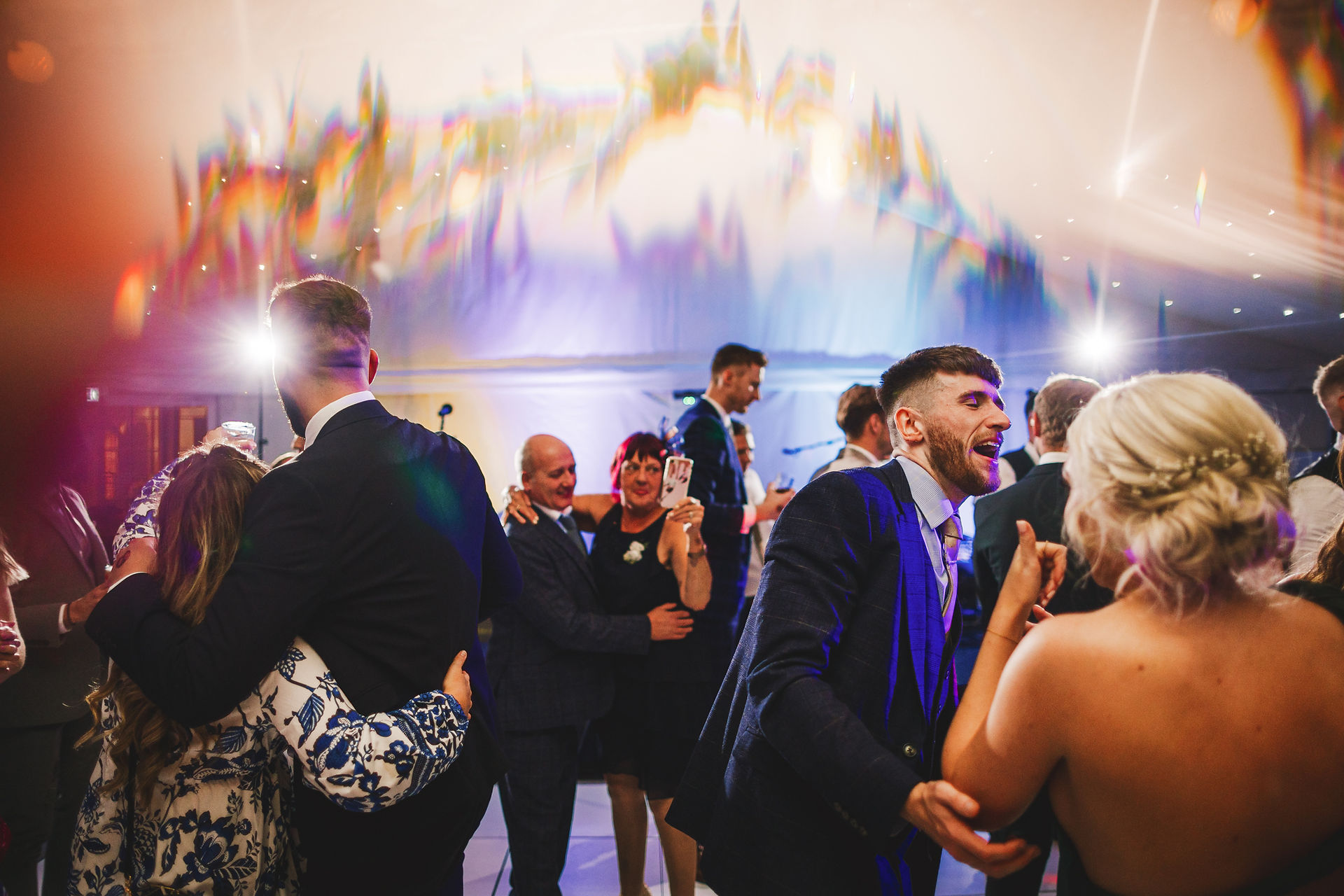 Guests dancing and celebrating at a wedding with lights and music Craig Hickey Photo.