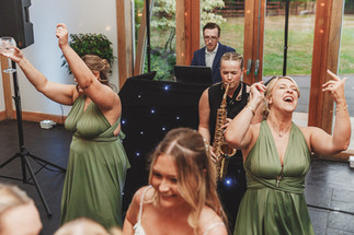 Mythe Barn wedding: Guests dancing, saxophonist playing