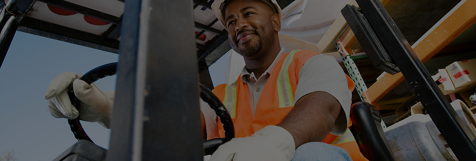 smiling magnitech employee driving forklift