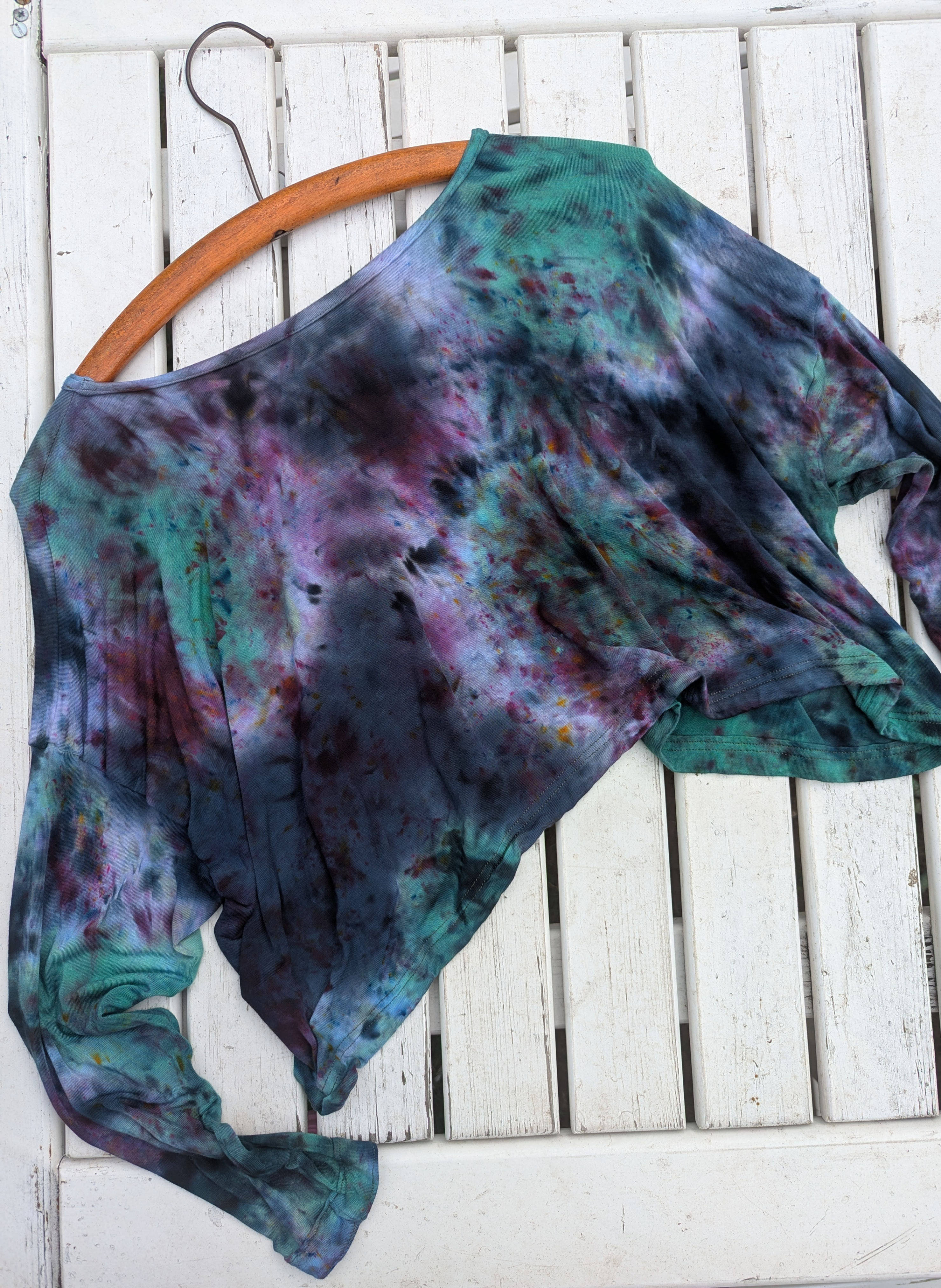 A tie dye, hand dyed slouchy crop top in alternative, gothic, witchy and whimsical black, purple, green colours.