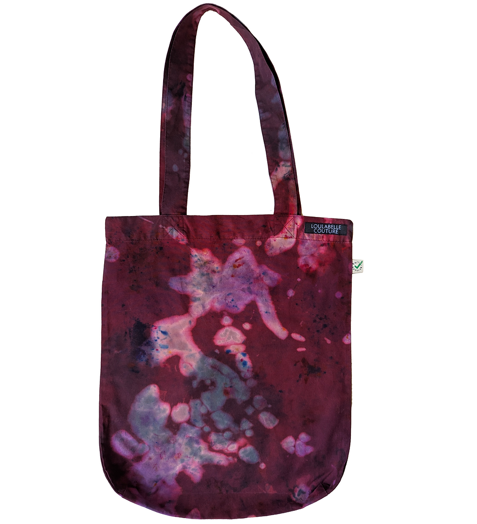 An organic cotton, earthpositive tote bag in a punk, grunge, alternative red, purple, lilac and black tie dye acid wash