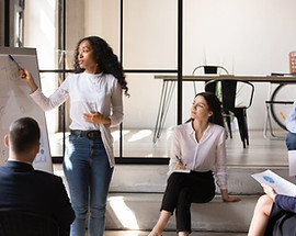 A group of people attending a lecture conducted by a woman.
