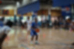 Eye-level view of a focused athlete tying running shoes on a track