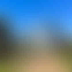 Walking path with a castle and large statute of a man riding a hourse