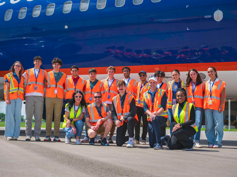 Group photo in front of aircraft