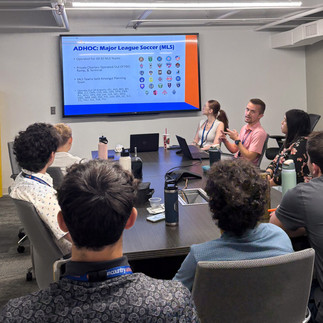 Meeting room with screen and people watching presentation