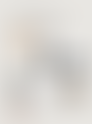 Minimal carry-on packing list for 5 nights in Mexico featuring neutral travel wardrobe essentials including straw hat, sunglasses, white tank, linen shorts, black and grey one-piece swimsuits, navy shorts, oversized button-down shirt, lightweight scarf, and brown flip flops.