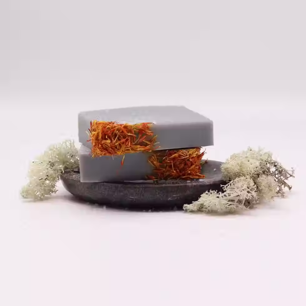 Coastal Wilderness sea salt and moss soap loaf displayed with sliced handmade soap