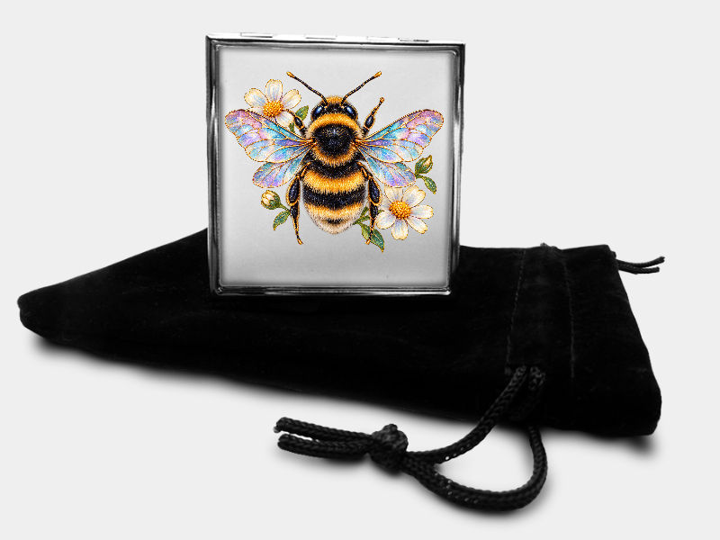 Square metal pill box with bumblebee and flower design and black velvet pouch