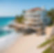 Beach Mansion overlooking the ocean with clear waters and a breezy sky.jpg