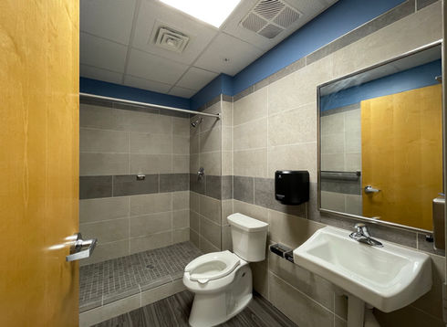 Bathroom with toilet, sink, and shower
