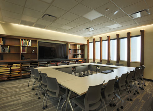 Modern conference room with a large screen and table
