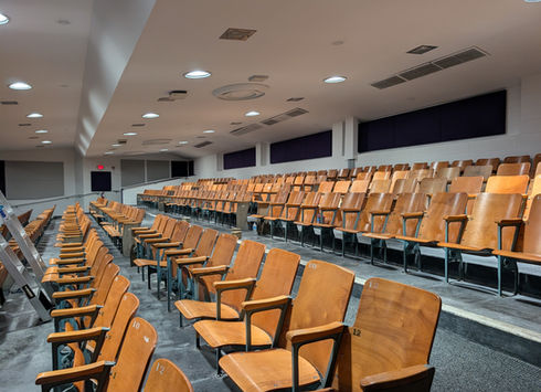 Balcony with rows of wooden auditorium seating