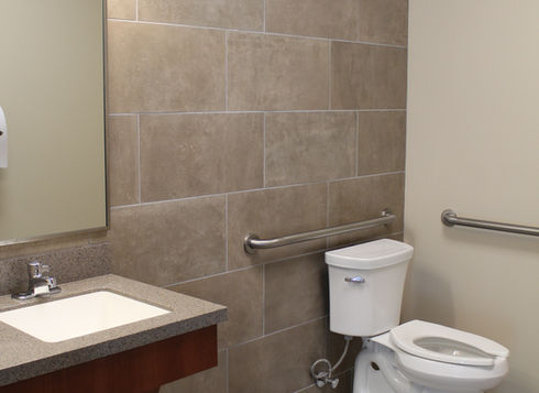 Accessible bathroom with sink, toilet, and grab bars