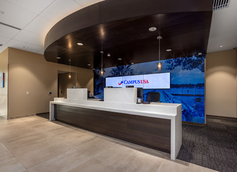 Modern bank teller area with CAMPUSUSA logo on screen