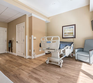 Hospital Bed, Sleeping chair, and door to restroom