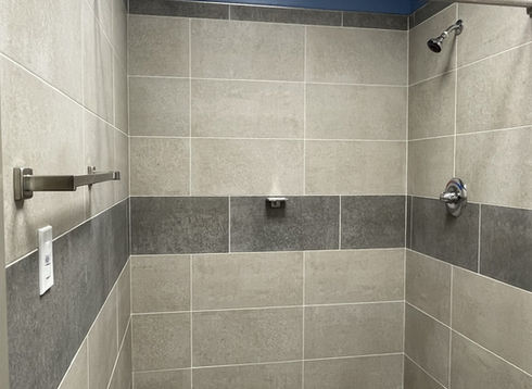 Clean shower with light and dark gray tiles
