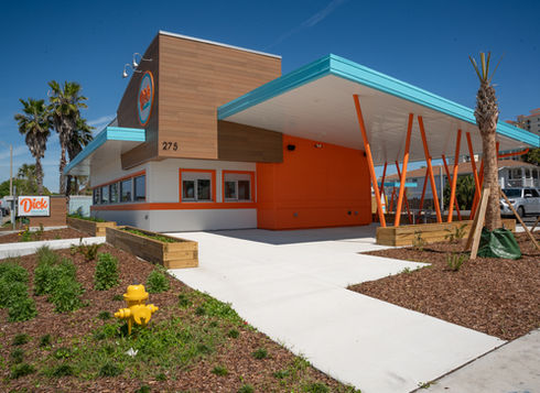 Fast-food building with outdoor seating, orange and blue accents