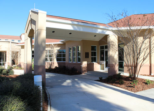 Building entrance with covered drop-off area walkway