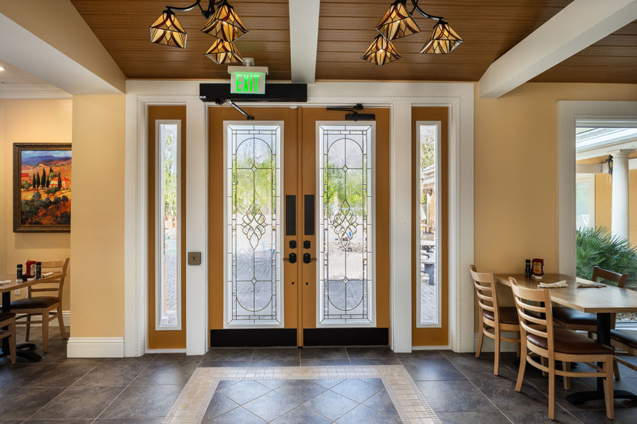 Elegant double doors with glass panels and surrounding interior restaurant setting