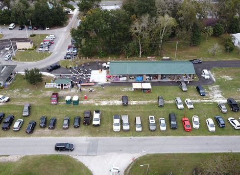 Aerial view of cars parked at a farmer's market pavilion