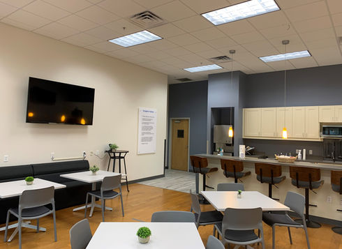 Employee breakroom with tables, chairs, and kitchenette