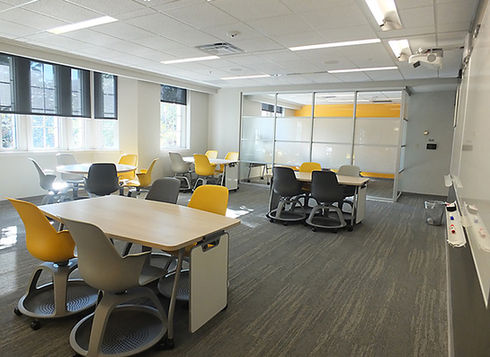 Modern classroom with yellow and grey chairs