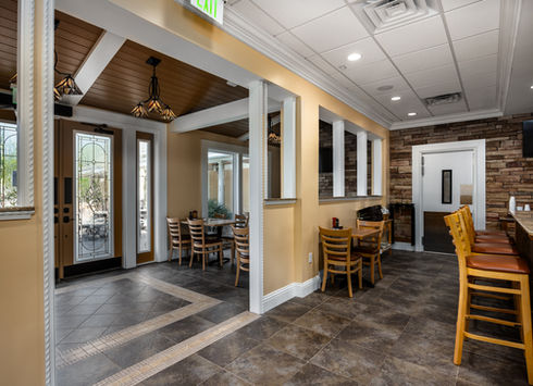 Cafe interior with dining tables and view of patio